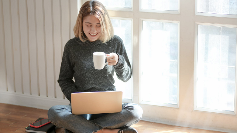 Woman with tea on computer