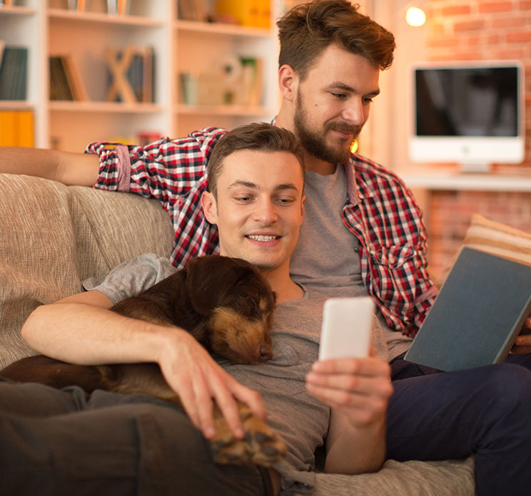 Couple on couch with cute dog