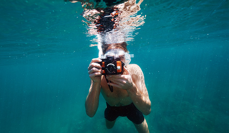 Swimmer with underwater camera