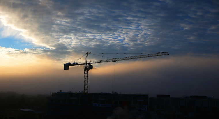 Commercial construction crane at sunset