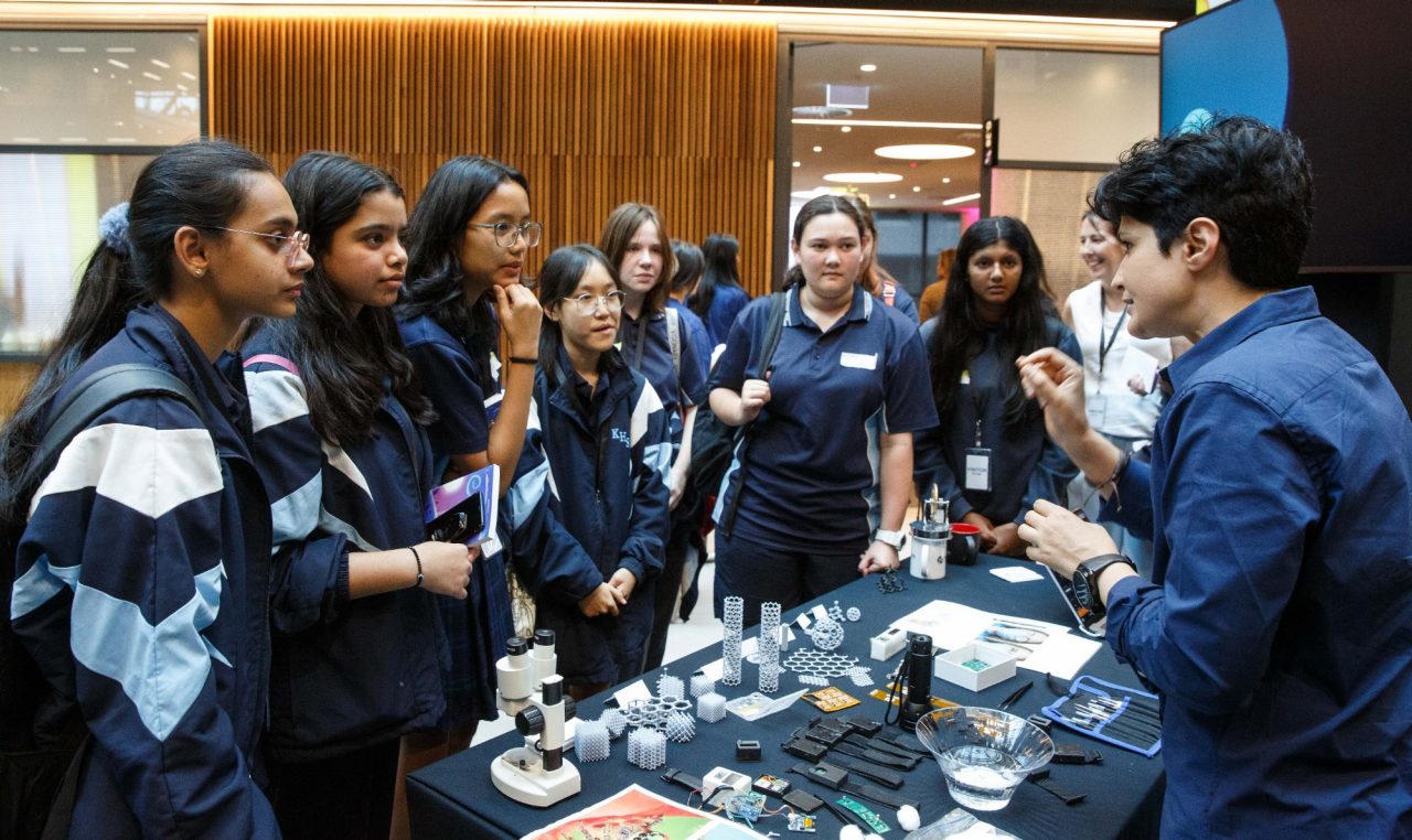 Students around a cyber security stand at Girls in Tech