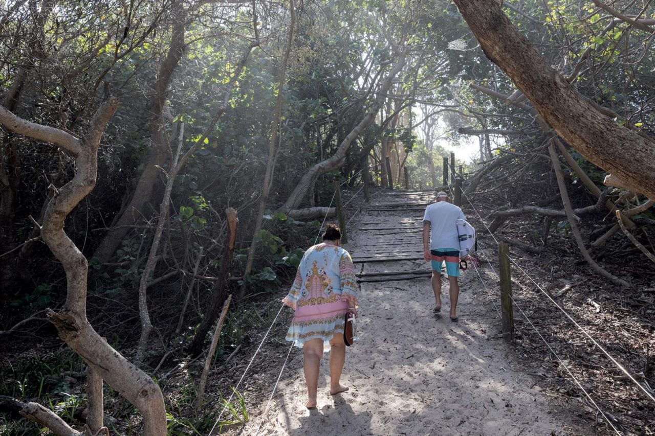 Couple-walking-on-beach-track