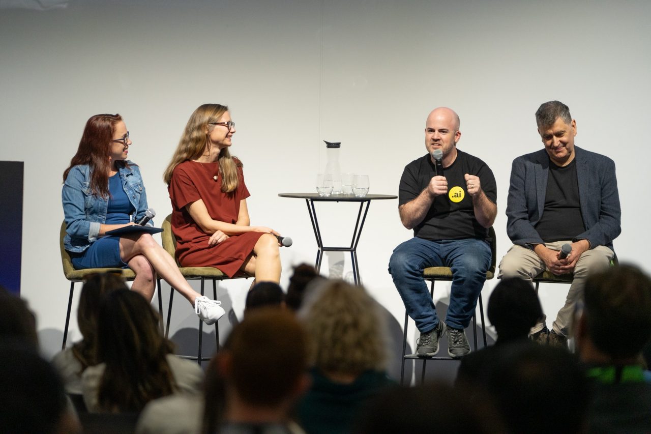 Four people holding microphones while sitting on a stage in front of an audience at SXSW Sydney 2024.