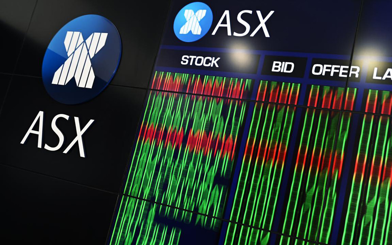 A trader looks at screens on the Wall Street trading floor