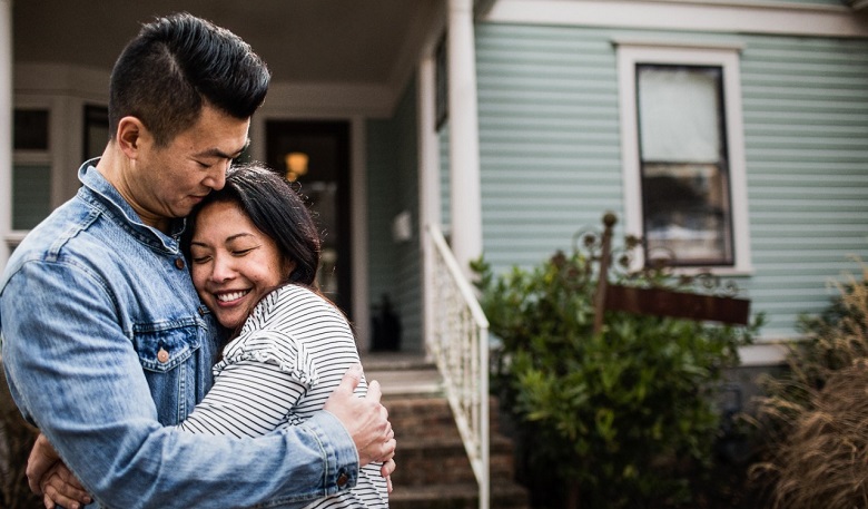 couple in front of home