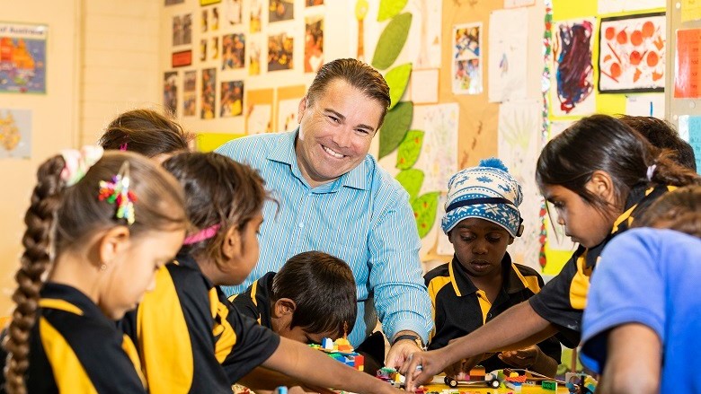 Teacher smiling with children