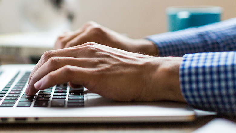 man typing laptop