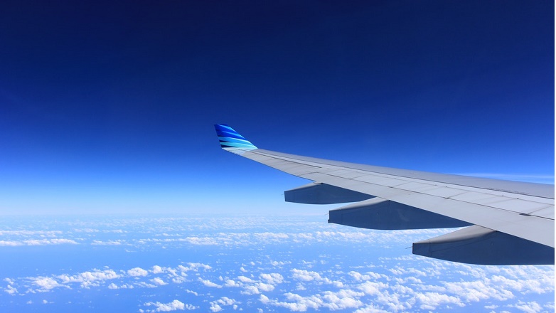 Aeroplane wing over blue skies