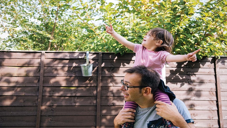 Daughter on dad's shoulders