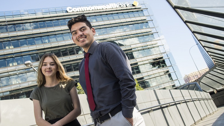 CBA Indigenous trainees Jake Haapu and Kiara Gordon in front of CBA building