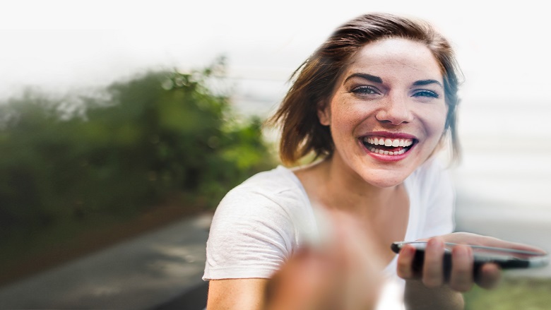 Woman smiling holding phone