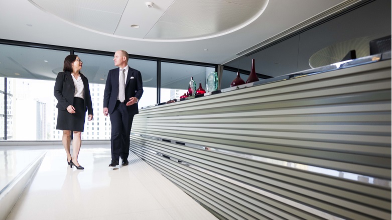 lawyers walk through an office foyer