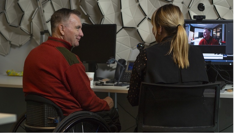 Man in wheelchair using technology in the CBA Innovation Lab