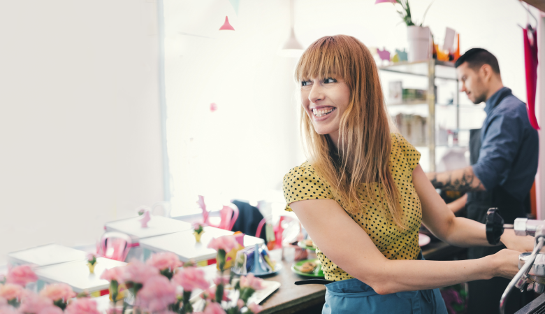 Woman making coffee smiling