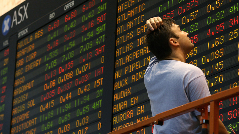 man looking at the ASX ticker board