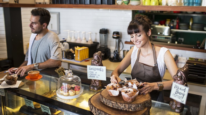 man and woman working in cafe