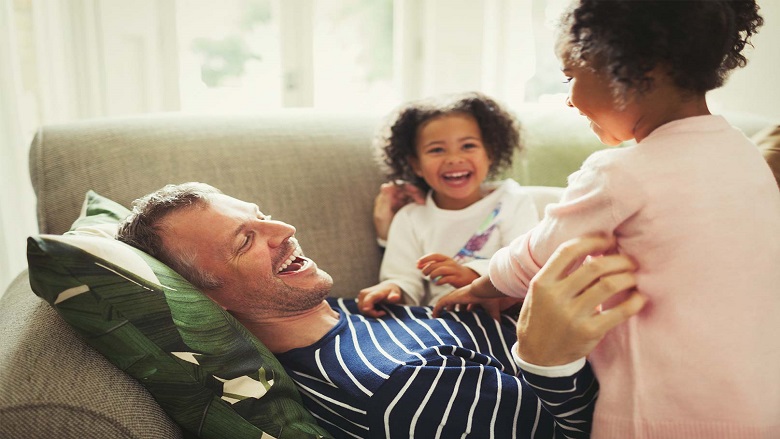 dad and daughters laugh