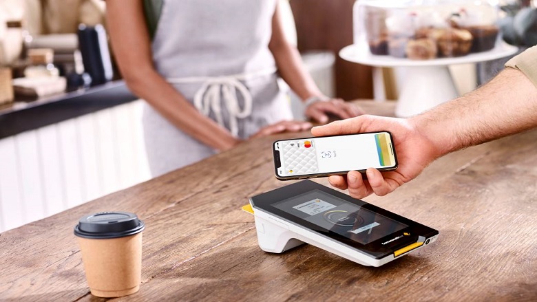 Person paying with Apple Pay on Albert terminal
