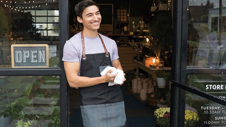 man in doorway of shop