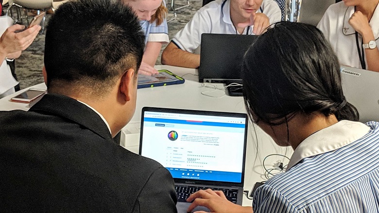 man and student looking at computer screen