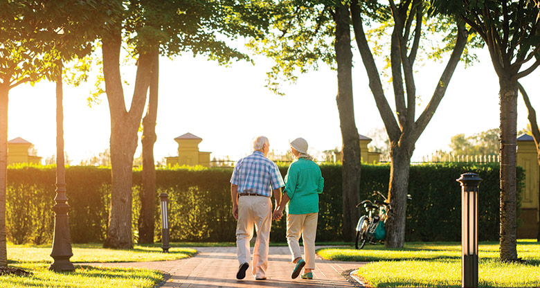 Image of an elderly couple walking together holding hands