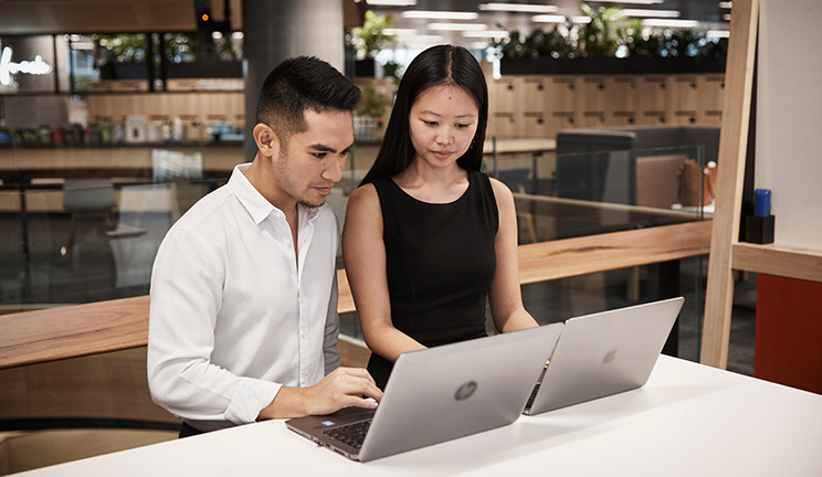 Graduates on laptops