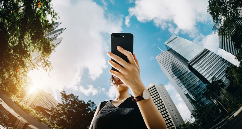 Woman holding phone outside