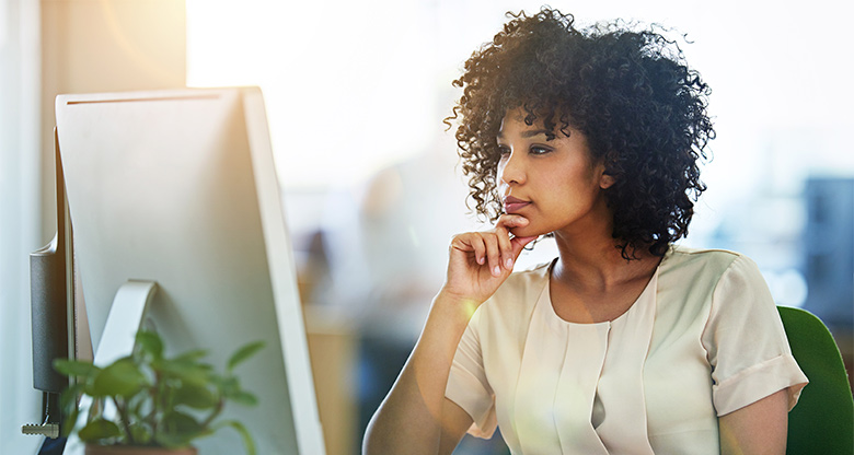 Woman studying computer screen