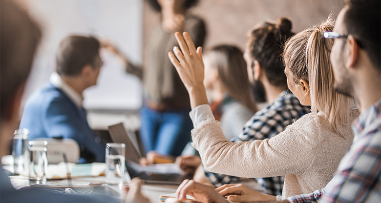 Staff member raising hand during meeting