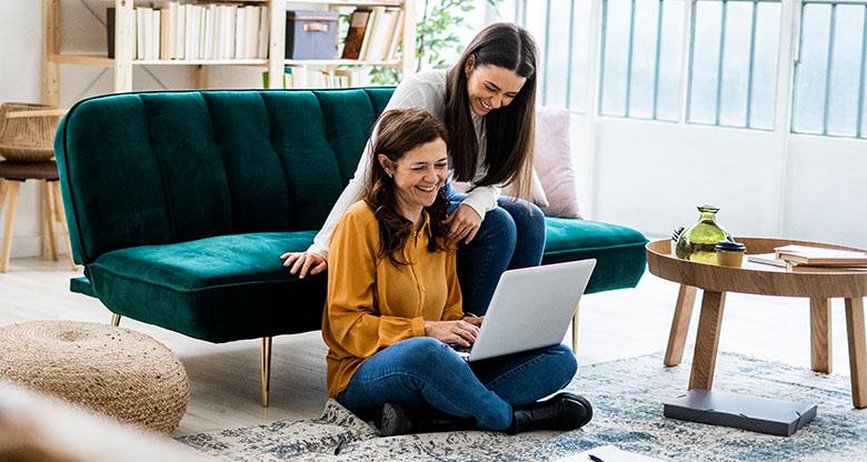 Mother and daughter looking at laptop together