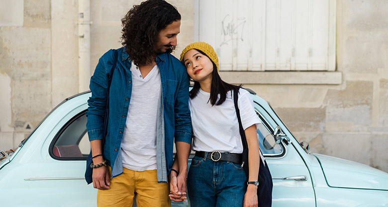 A young couple with their car