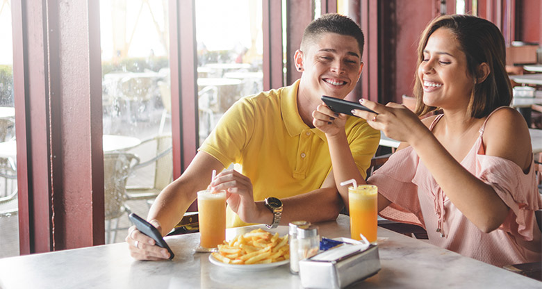 A couple looking at a phone budgeting