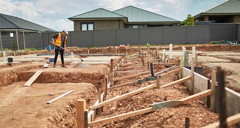 Man working on house and land construction site