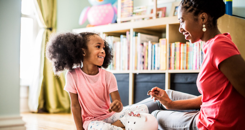 A mother teaching her daughter about money