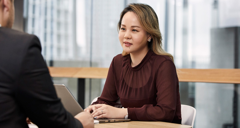 CommBank staff member in meeting with laptop