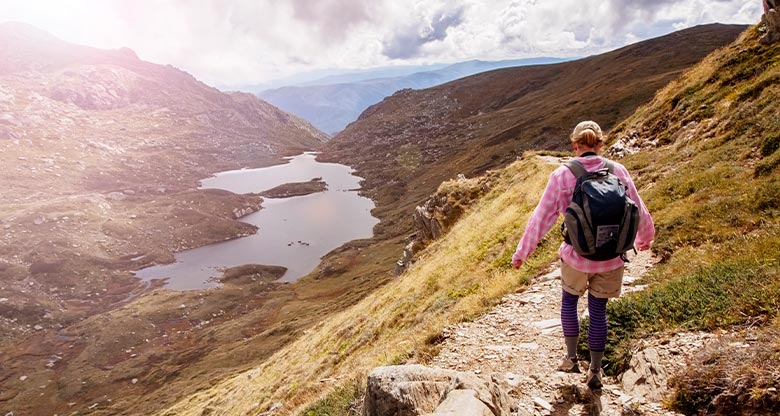 Woman hiking through mountains