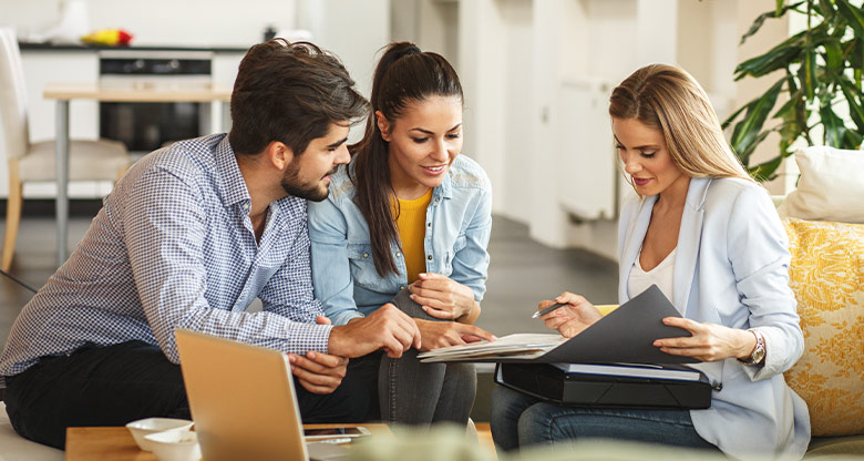 Couple talking through options with real estate agent