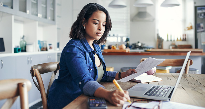 Woman calculating property offer at desk