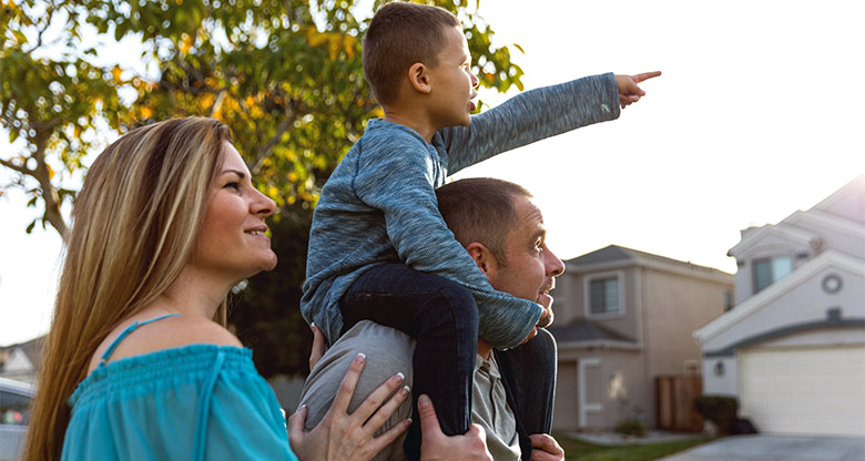 Family observing house on street