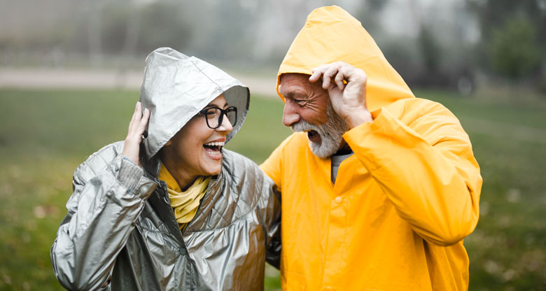 Couple in rain wearing raincoats