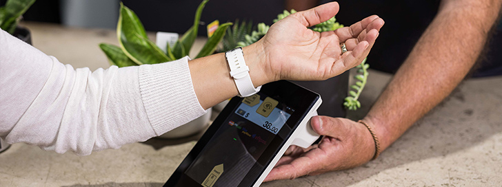 Person using watch to pay in store