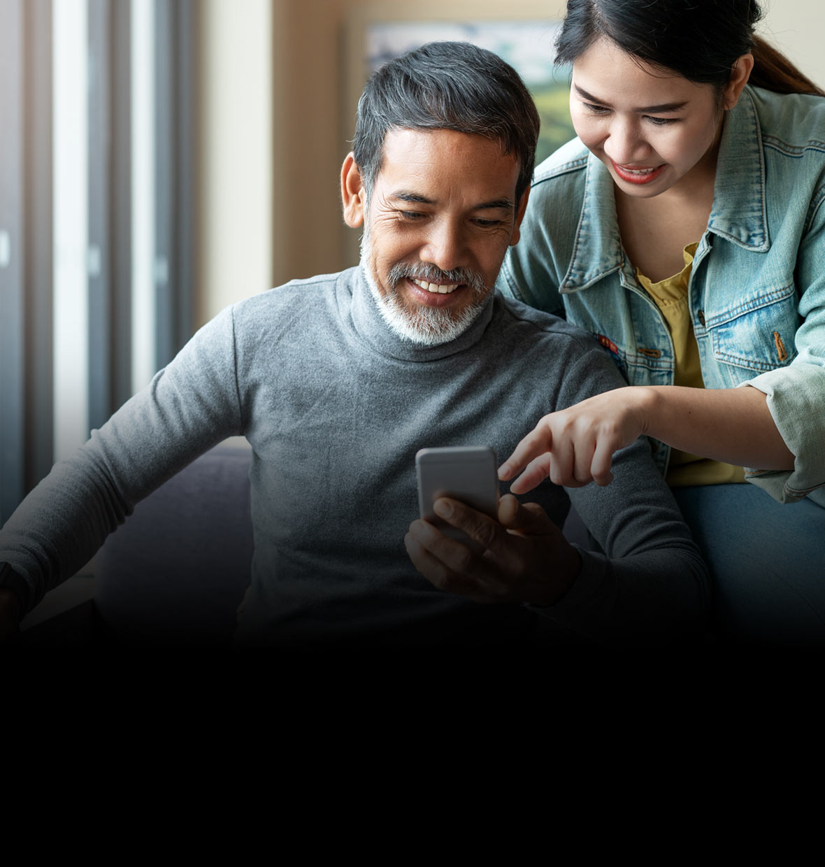 A father and his daughter browsing online on a phone