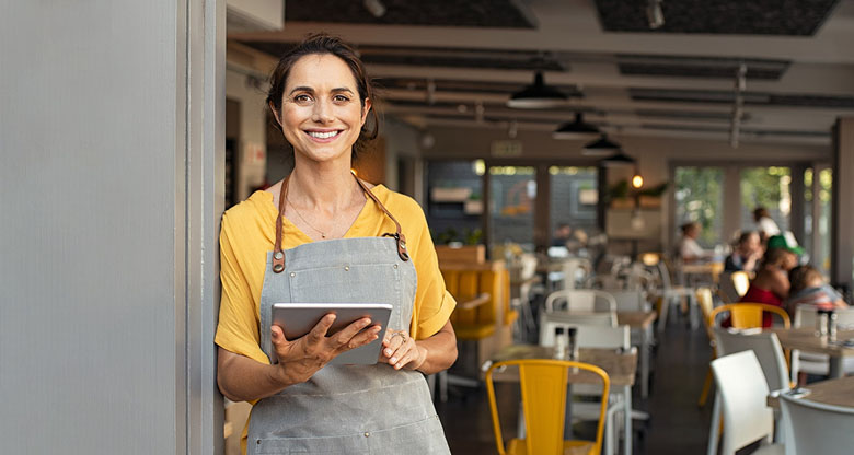 Image of a hospitality worker holding a tablet