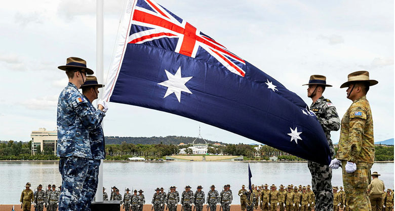 Image of army officers pulling the flag