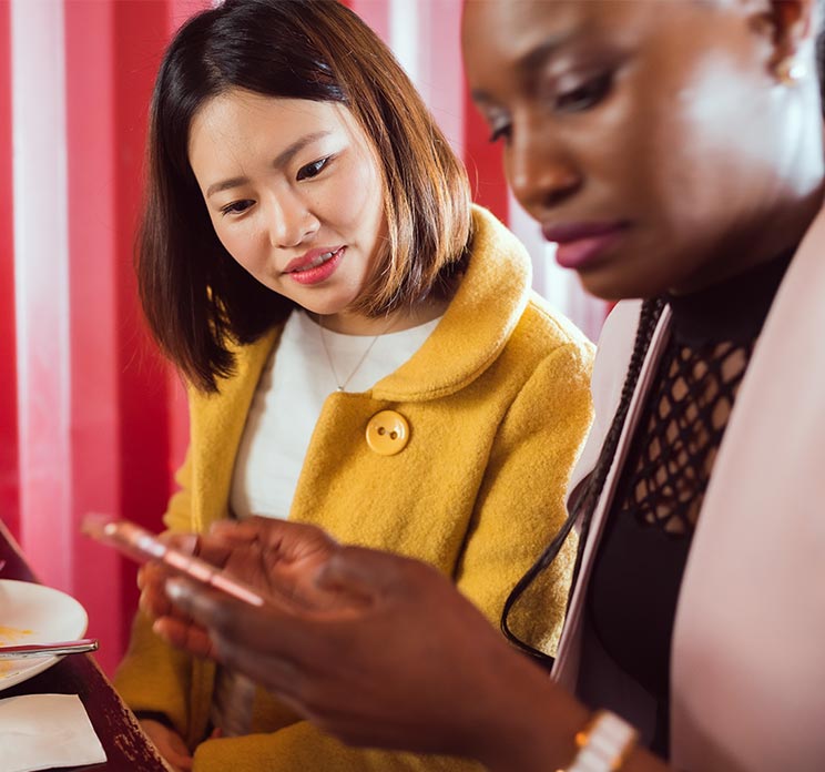 two women looking at phone