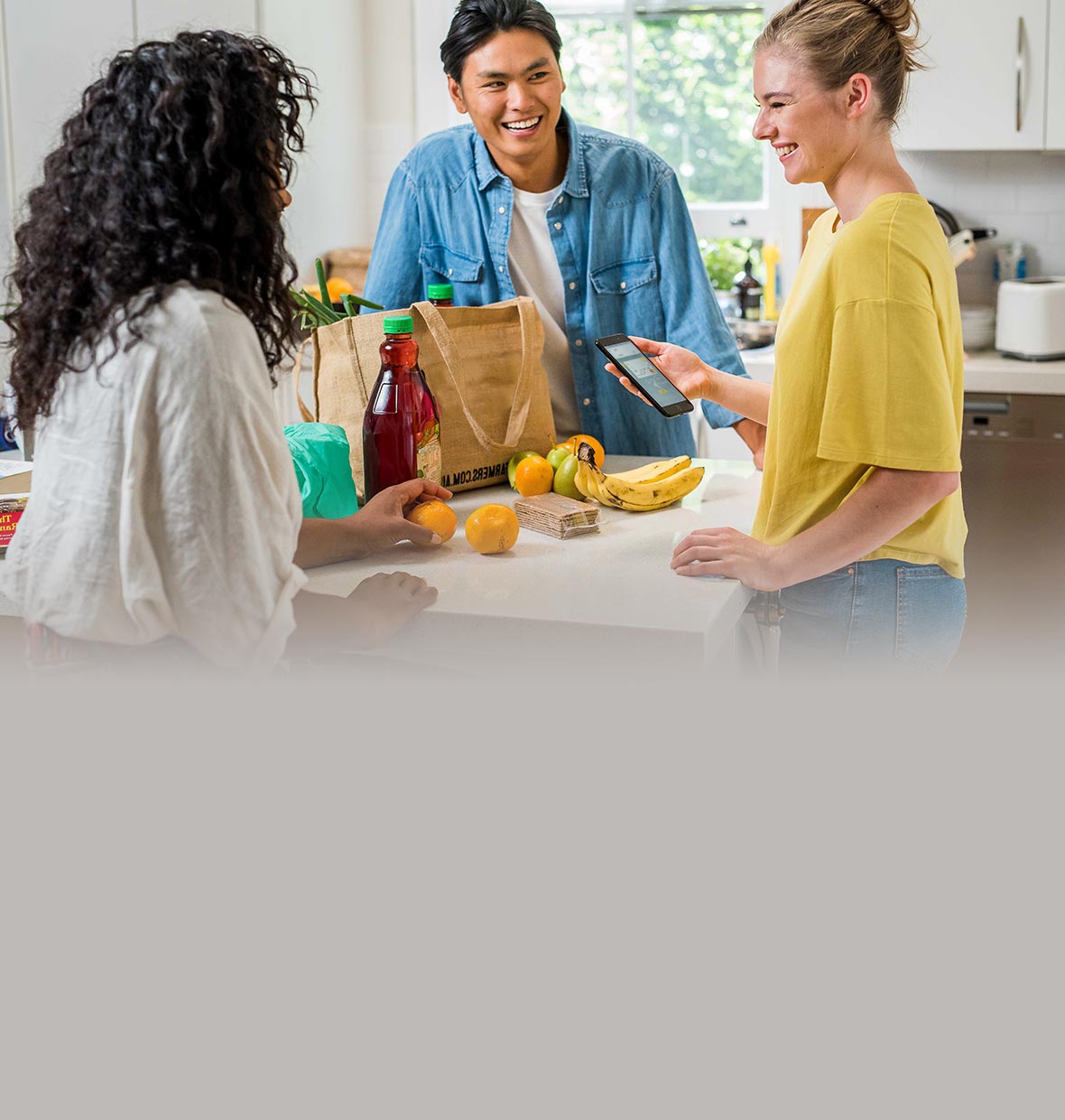 friends in kitchen with shopping