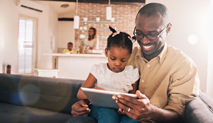 father daughter looking at a tablet