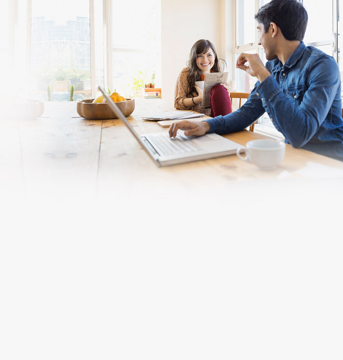 woman looking at man on laptop