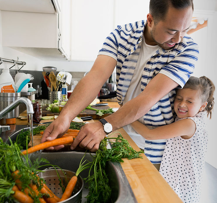 Father and daughter in kitchen