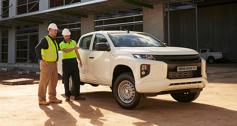 Men standing next to the ute